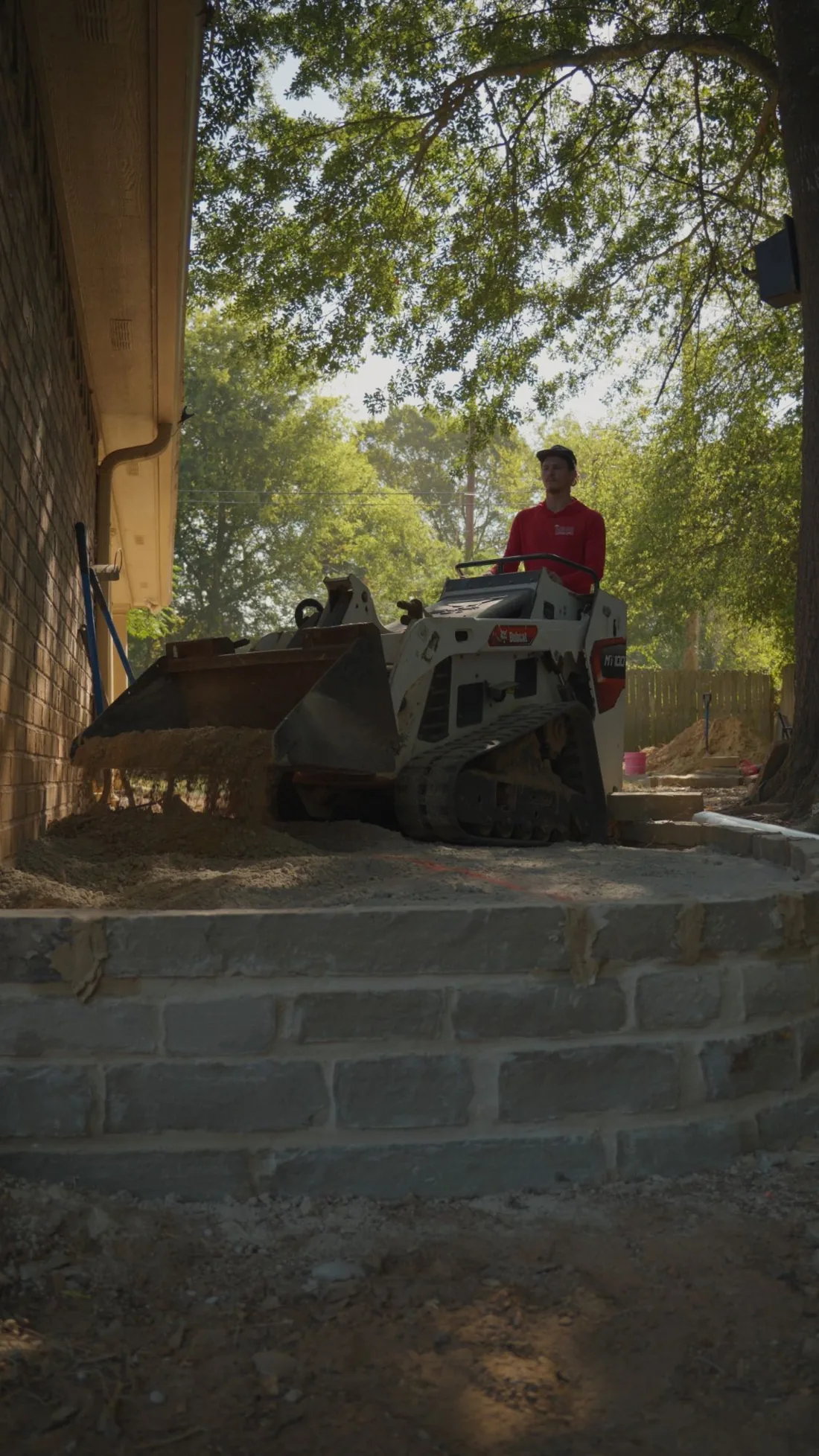 Backfilling the elevated corner of a flagstone patio in White Oak, Texas